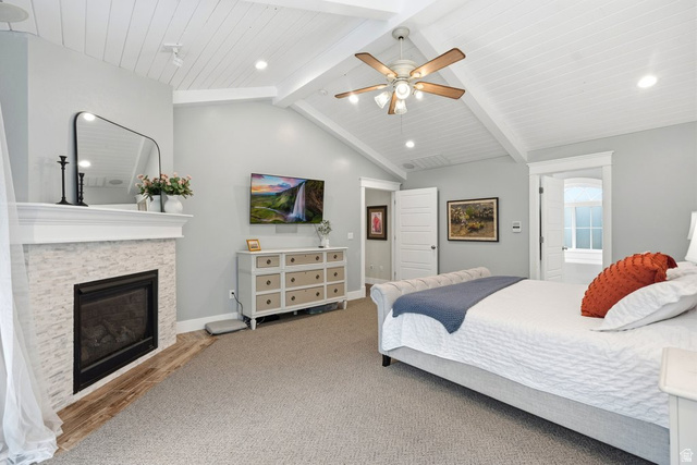 672 Perry Hollow Drive Mapleton, UT 84664 - Photo 44 of 106 Spacious room featuring vaulted ceilings with exposed beams and shiplap, a fireplace with a stone surround and wood-finish hearth, recessed lighting, and a ceiling fan