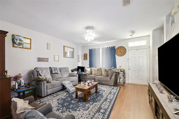 a living room with furniture and a flat screen tv