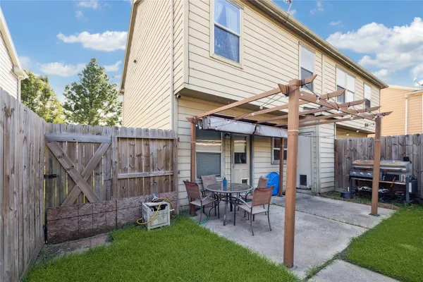 a view of a house with backyard and a patio