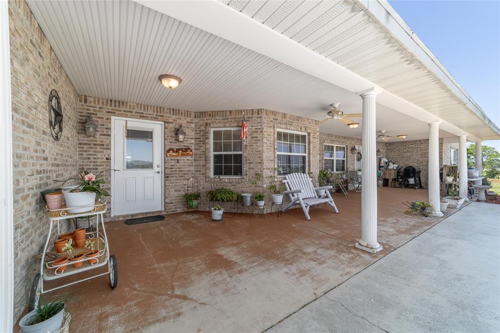 19355 Southwest 25th Place Dunnellon, FL 34431 - Photo 25 of 73 a view of a patio with table and chairs and potted plants