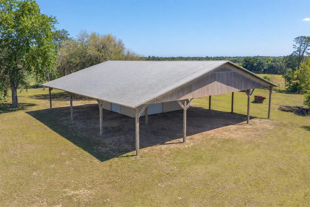 19355 Southwest 25th Place Dunnellon, FL 34431 - Photo 4 of 73 a backyard of a house with wooden fence and large trees