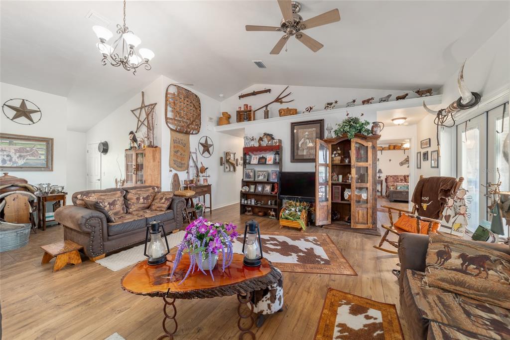 19355 Southwest 25th Place Dunnellon, FL 34431 - Photo 42 of 73 a living room with lots of furniture and a chandelier