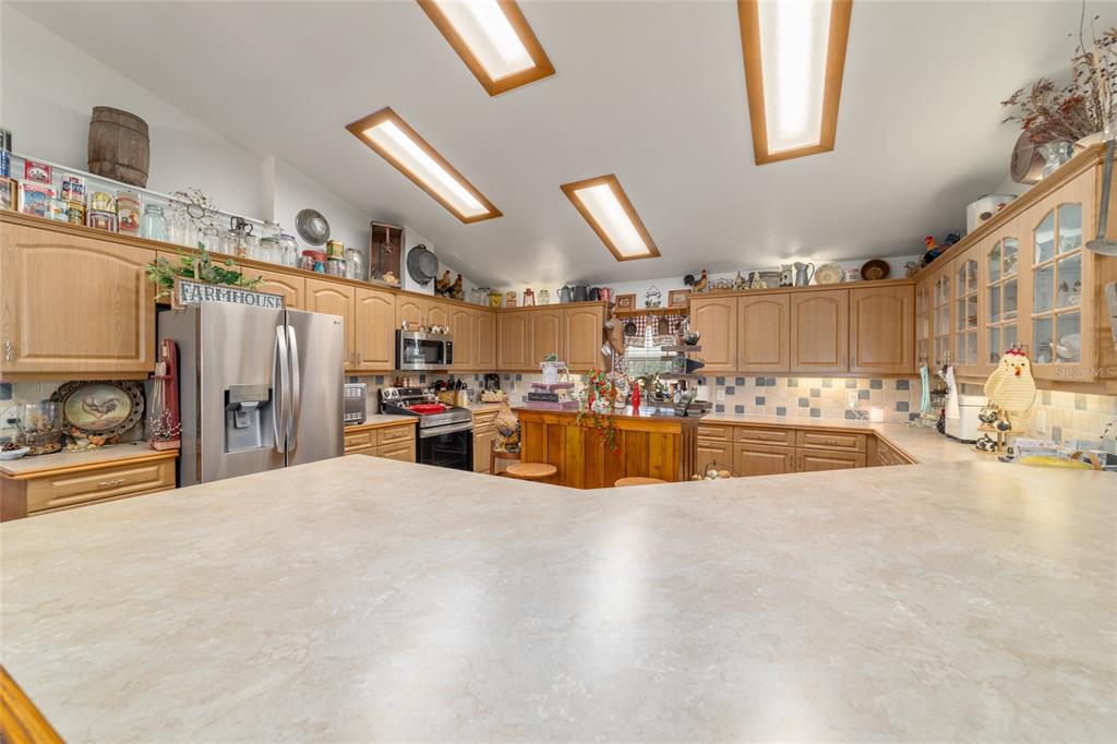 19355 Southwest 25th Place Dunnellon, FL 34431 - Photo 58 of 73 a large white kitchen with lots of counter space and windows