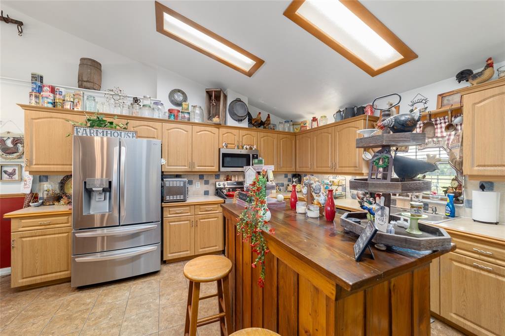 19355 Southwest 25th Place Dunnellon, FL 34431 - Photo 60 of 73 a kitchen with refrigerator and cabinets