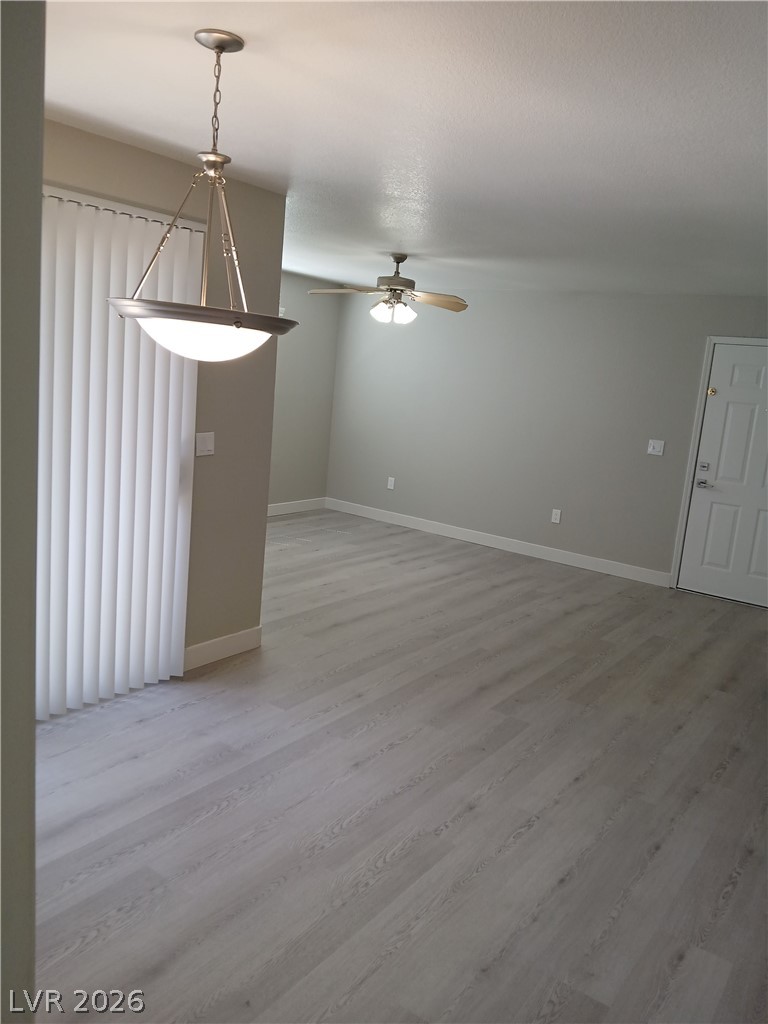 555 East Silverado Ranch Boulevard, Unit 1098 Las Vegas, NV 89183 - Photo 9 of 10 A versatile living area with light wood-tone flooring offers a neutral canvas for your design aspirations.