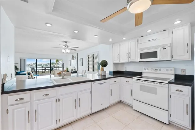 a kitchen with white cabinets and white appliances