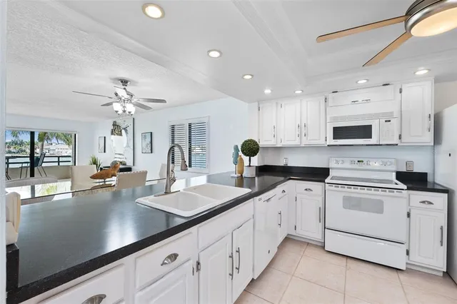 a large kitchen with a sink and chandelier