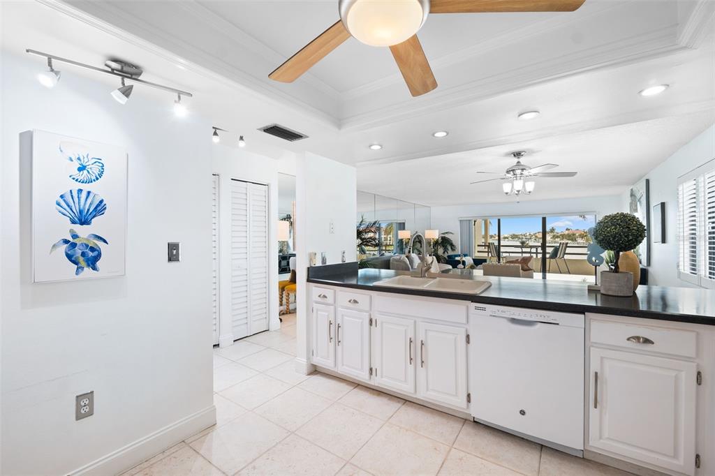 138 1st Street East, Unit 106 Tierra Verde, FL 33715 - Photo 18 of 62 a large kitchen with a sink and chandelier