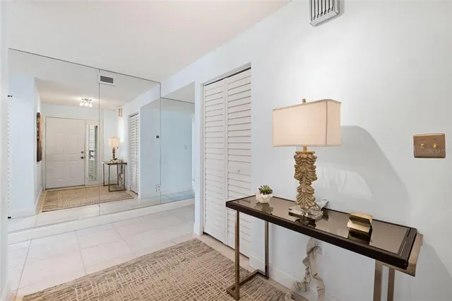 a bathroom with a light fixture a mirror and a sink