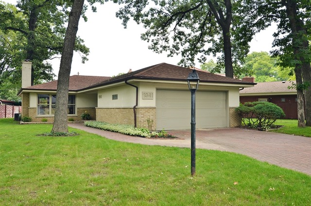 1341 South Knight Avenue Park Ridge, IL 60068 - Photo 1 of 10 a front view of a house with a garden
