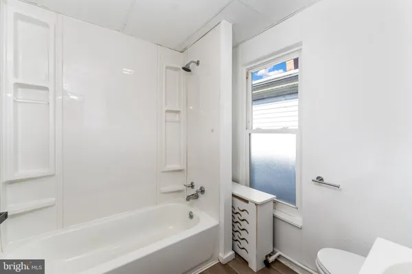 a bathroom with a granite countertop toilet tub and a shower