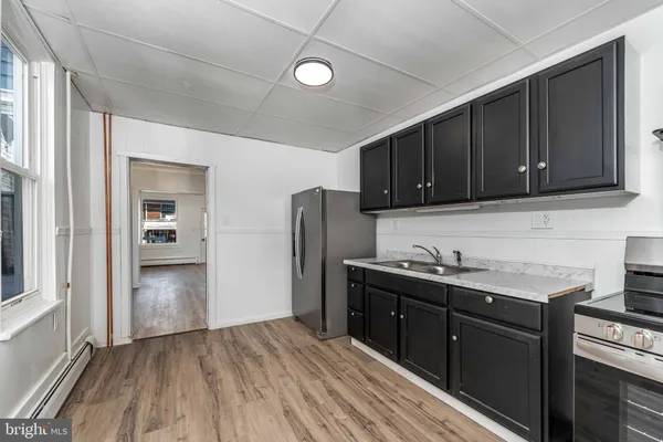 a kitchen with a sink and wooden cabinets