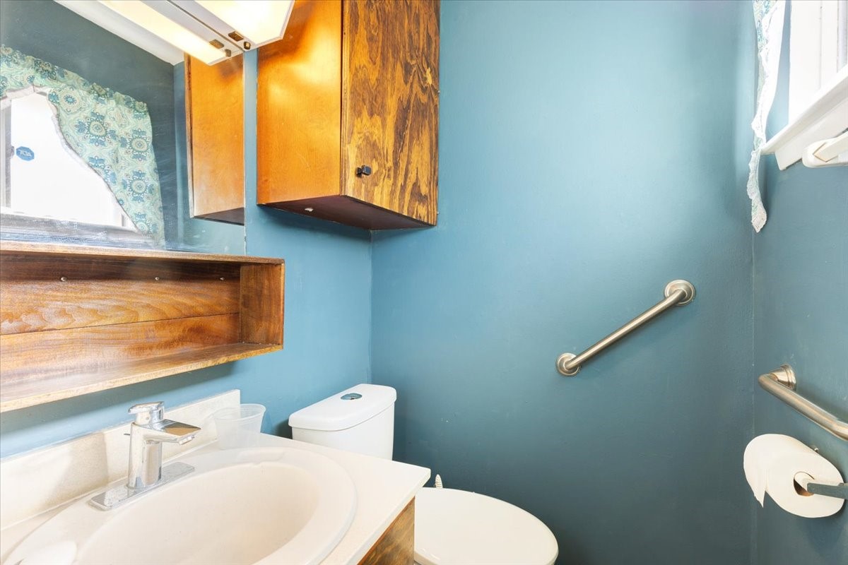 14518 Littleford Street Houston, TX 77045 - Photo 11 of 16 a bathroom with a toilet sink and mirror