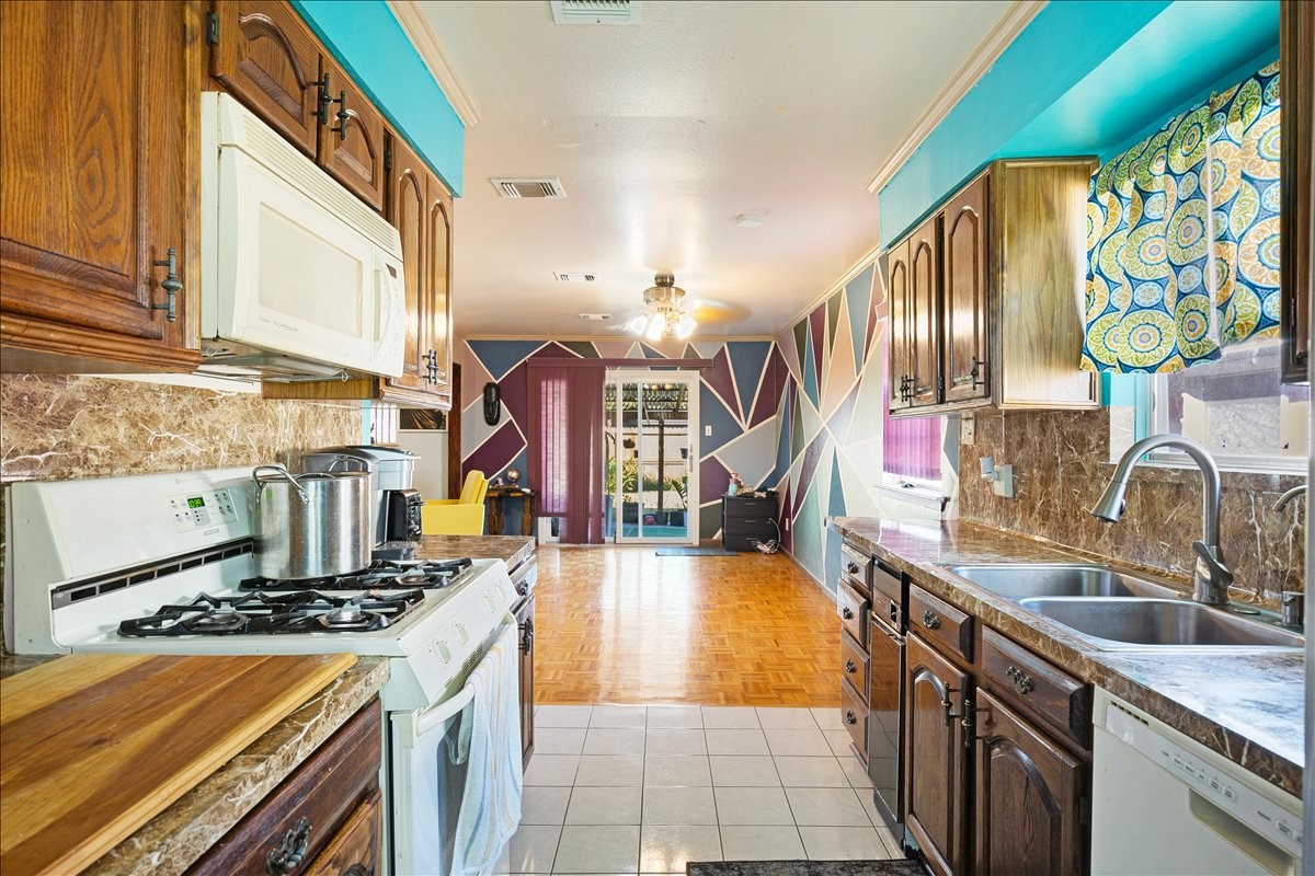 14518 Littleford Street Houston, TX 77045 - Photo 6 of 16 a kitchen with stainless steel appliances granite countertop a stove and a sink