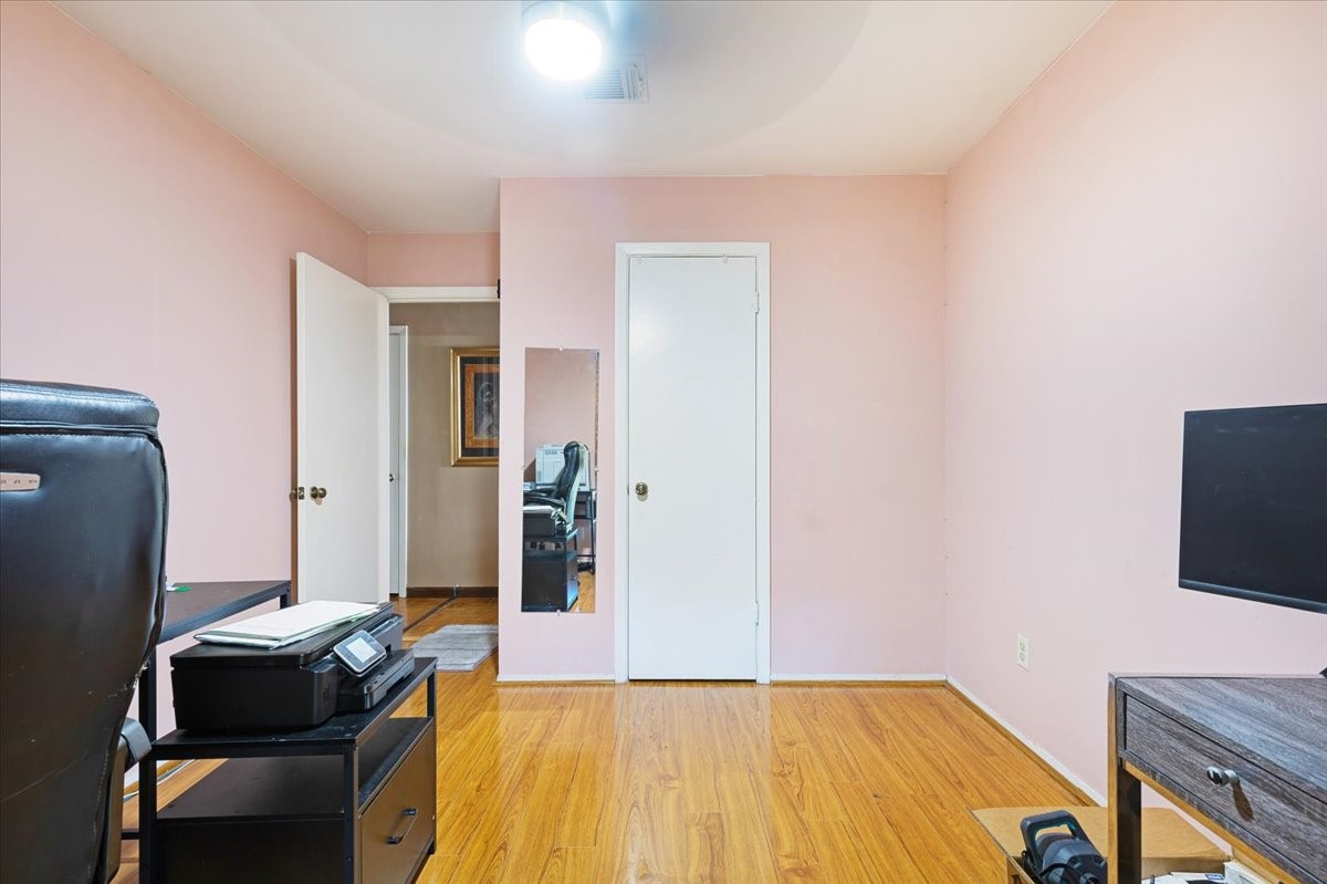 14518 Littleford Street Houston, TX 77045 - Photo 7 of 16 a workspace with furniture and wooden floor