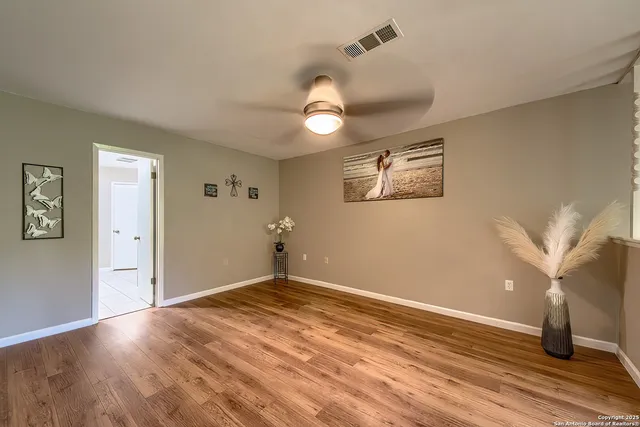 wooden floor in an empty room with a window