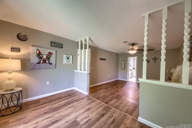a view of a livingroom with wooden floor and furniture