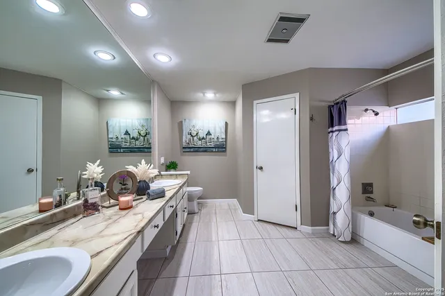 a room with a large mirror and furniture