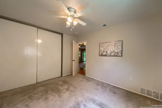 a view of a livingroom with a chandelier fan