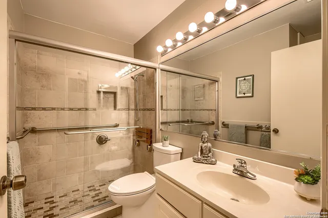 a bathroom with a sink toilet and shower