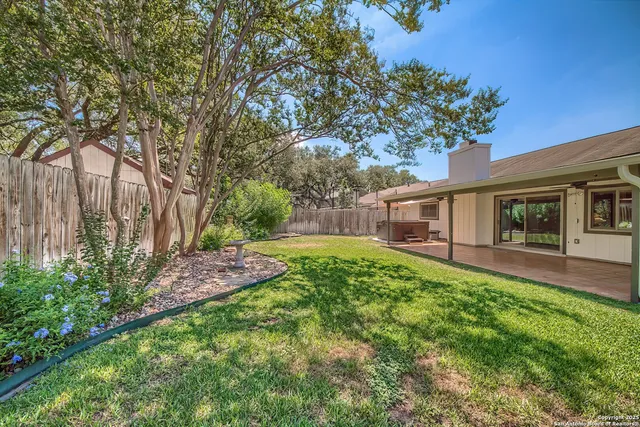 a backyard of a house with table and chairs
