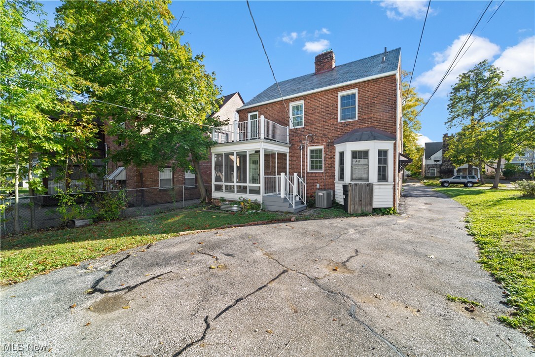 3690 Daleford Road Cleveland, OH 44120 - Photo 41 of 45 Back of property with a sunroom, brick siding, and a chimney