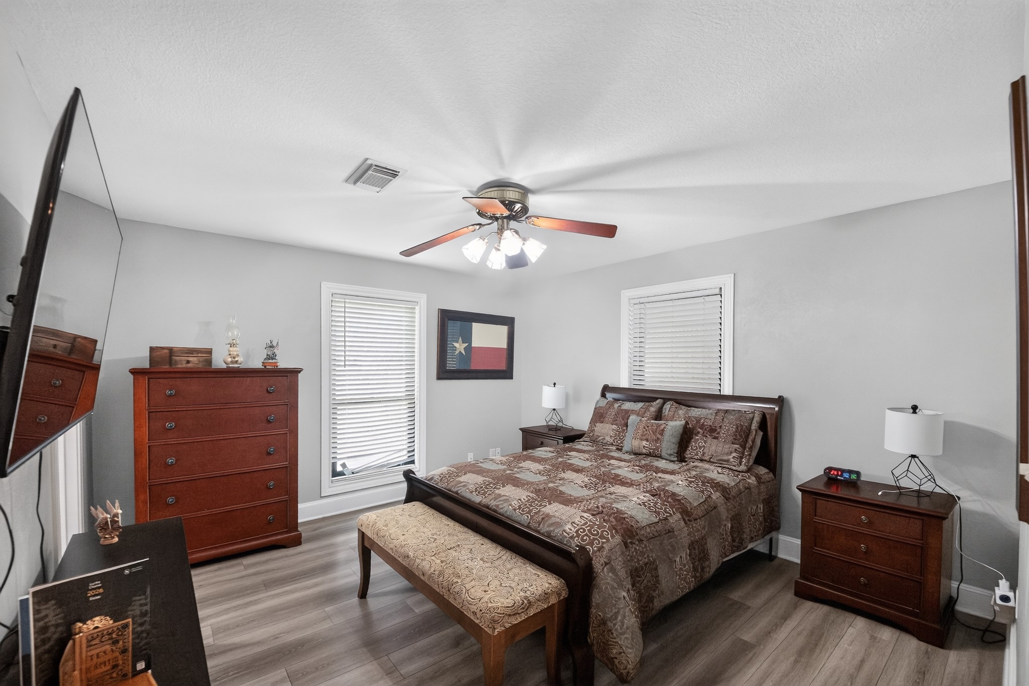1950 Country Club Road Brenham, TX 77833 - Photo 17 of 39 Relaxation awaits in this comfortably appointed bedroom, featuring durable flooring and ample natural light.