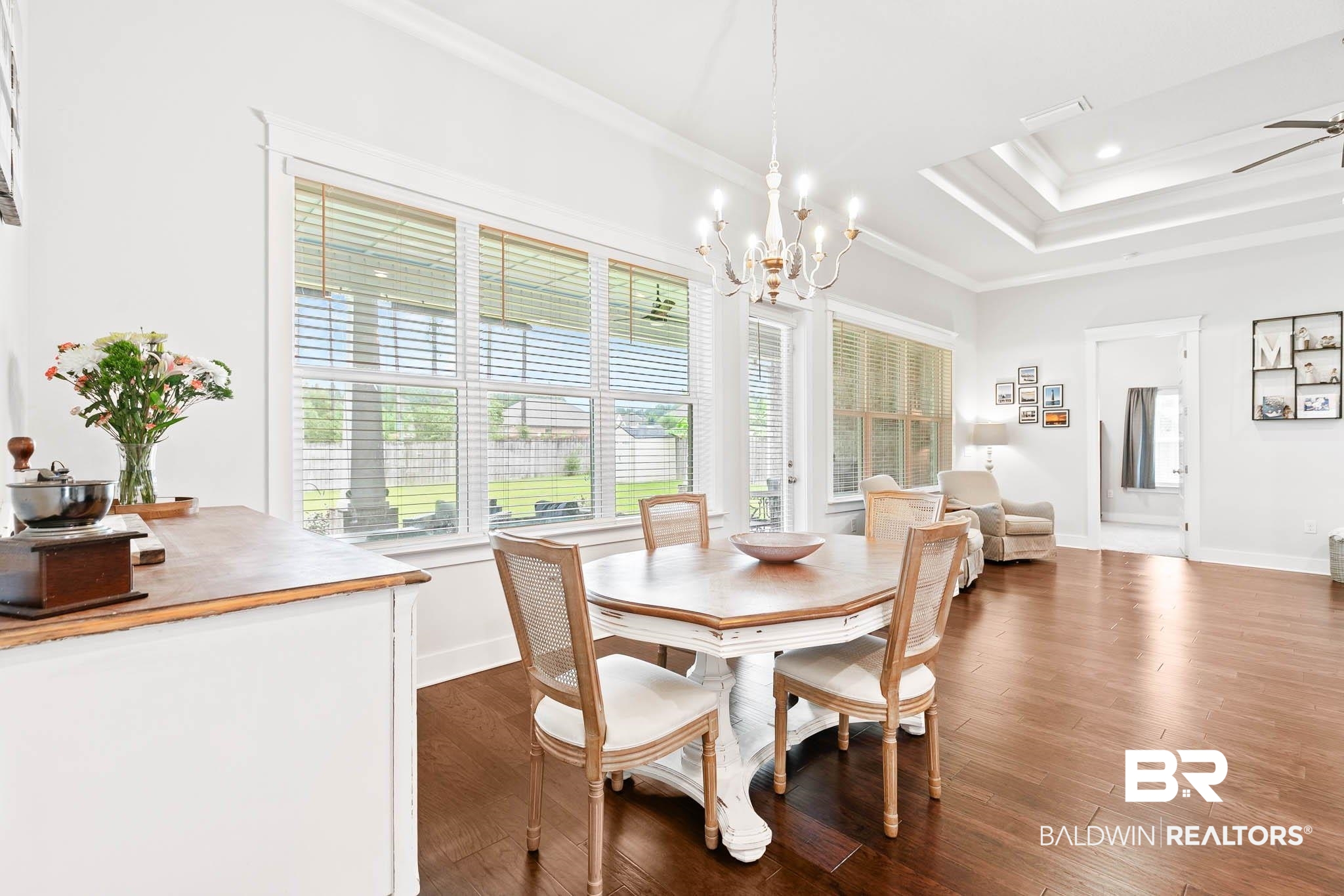 12785 Warbler Street Daphne, AL 36527 - Photo 24 of 53 Dining room featuring ornamental molding, a raised ceiling, dark wood finished floors, a chandelier, and recessed lighting
