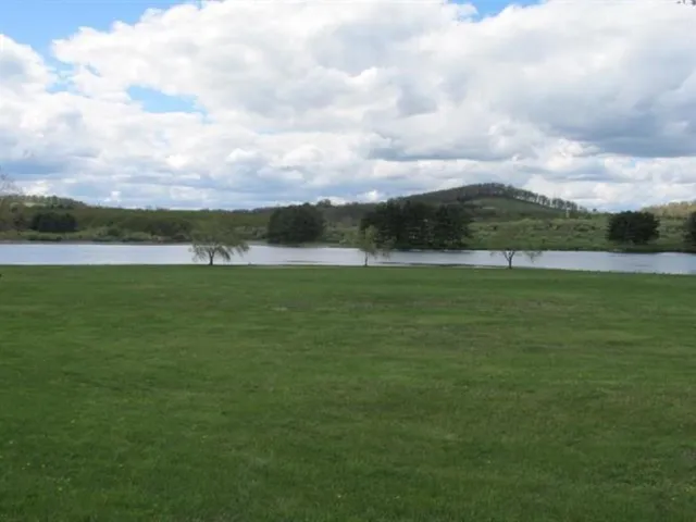 a view of a lake with a big yard