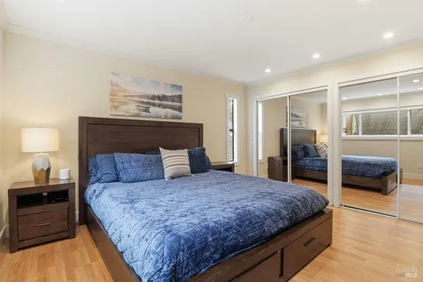 a bedroom with a large bed and a dresser
