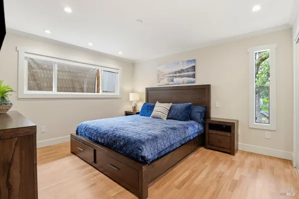 a bedroom with a bed and windows