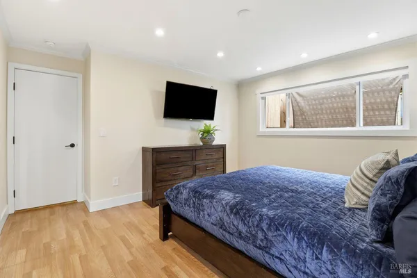 a bedroom with a bed and a flat screen tv