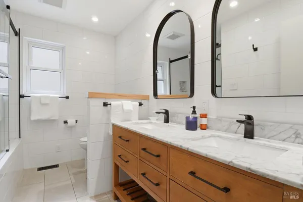 a bathroom with a granite countertop sink mirror and vanity