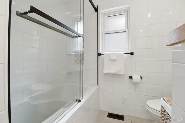 a bathroom with a shower and a toilet