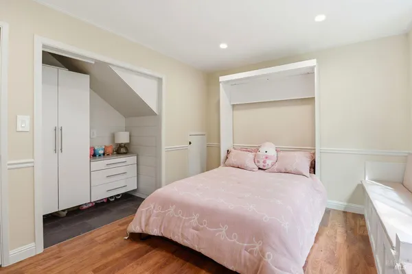 a bedroom with a bed and a dresser