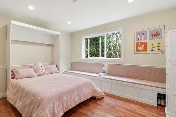 a bedroom with a bed and a large window