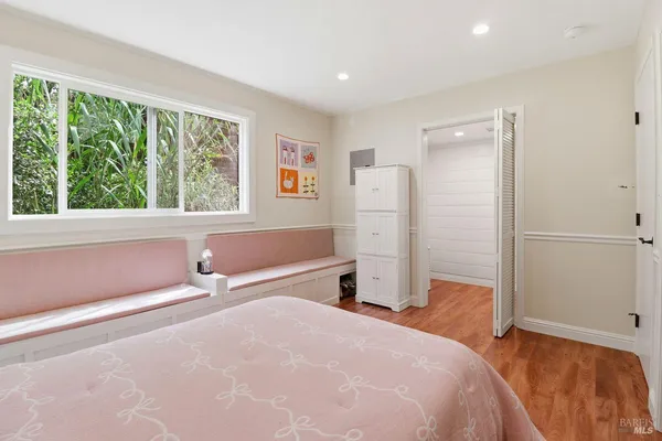 a bedroom with a bed and a large window