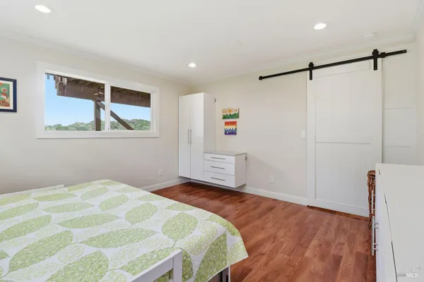 a bedroom with a bed and a window