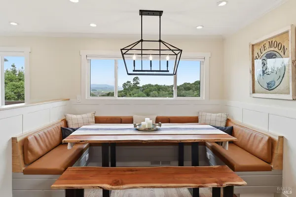 a kitchen that has a couch and a large window
