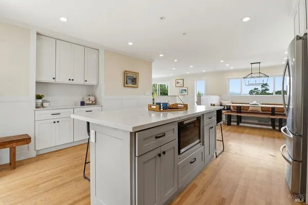 a kitchen with white cabinets and white appliances