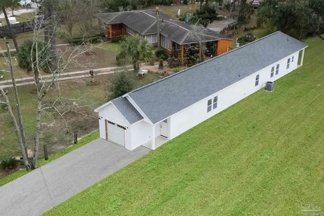 a view of house with pool and yard