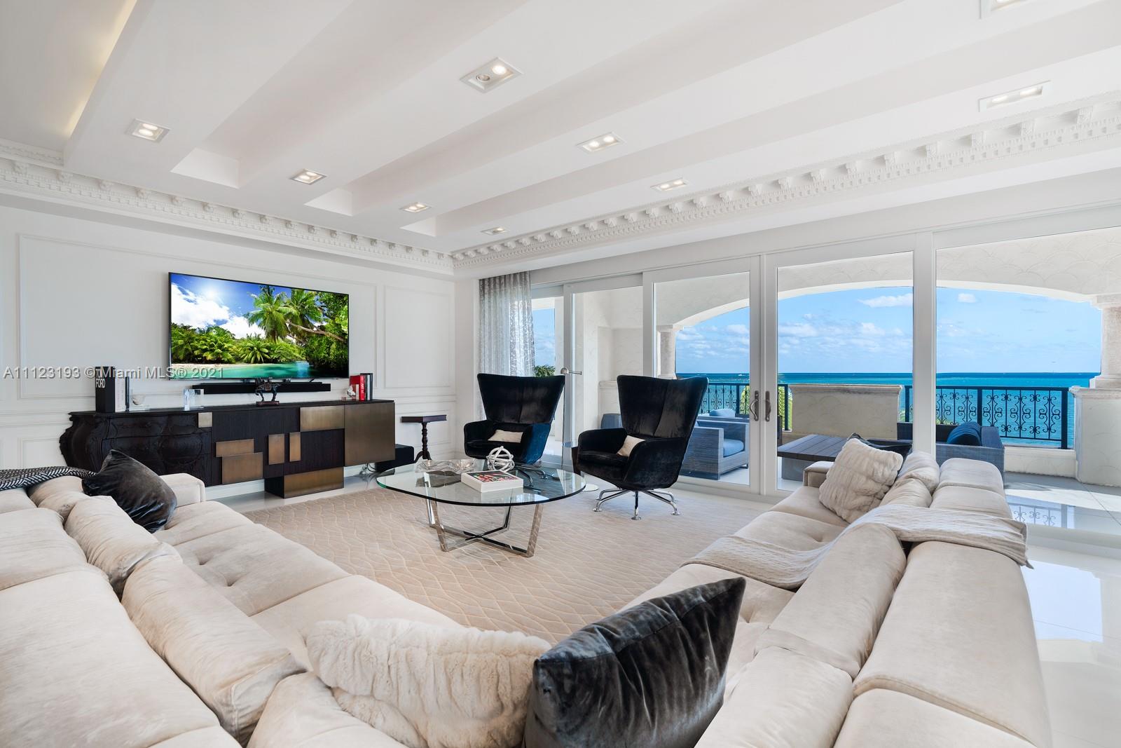 a living room with furniture large window and flat screen tv