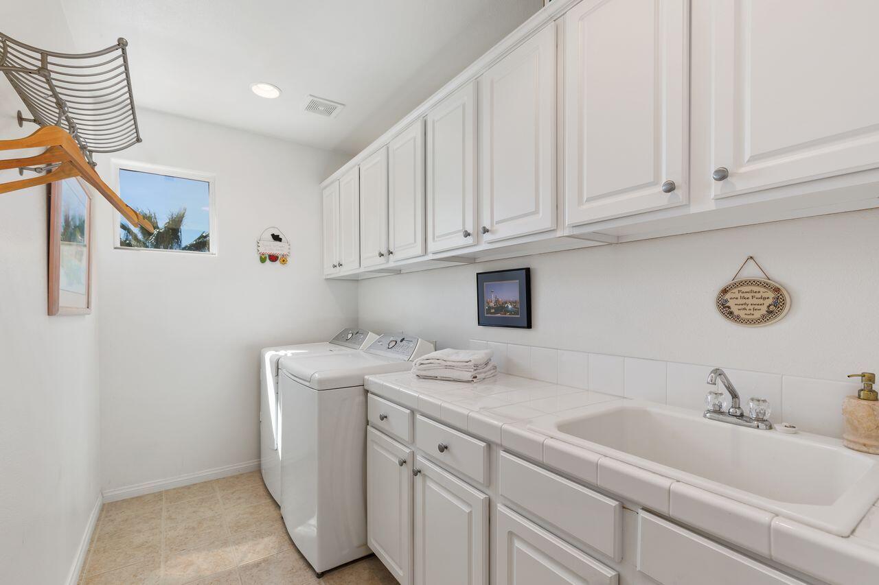 80591 Tangelo Court Indio, CA 92201 - Photo 11 of 30 a utility room with sink dryer and washer