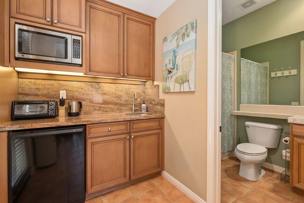 80591 Tangelo Court Indio, CA 92201 - Photo 19 of 30 a bathroom with a granite countertop sink and a toilet