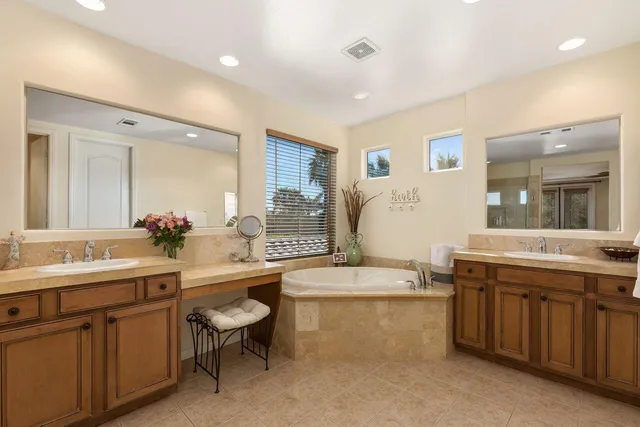 a bathroom with a granite countertop toilet sink and mirror