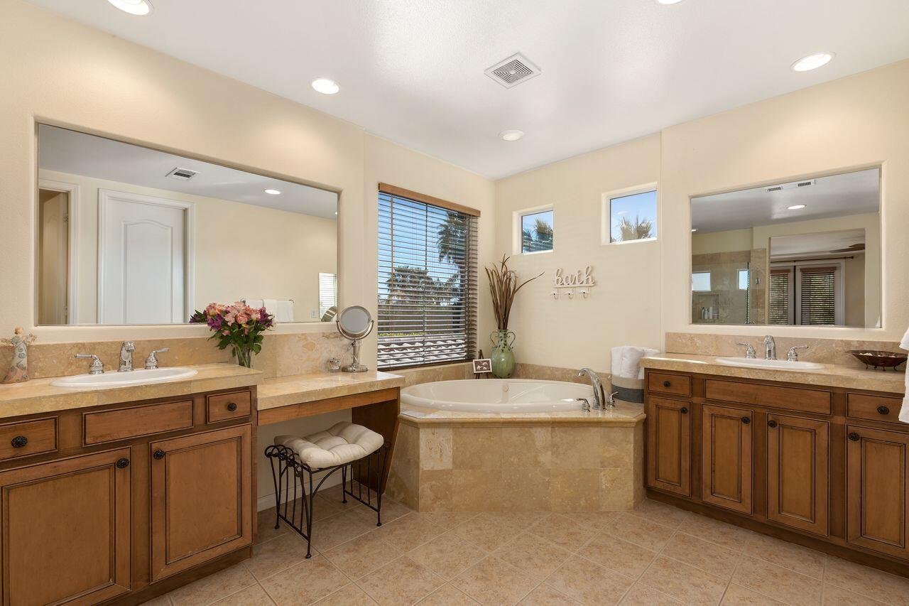 80591 Tangelo Court Indio, CA 92201 - Photo 21 of 30 a bathroom with a granite countertop toilet sink and mirror