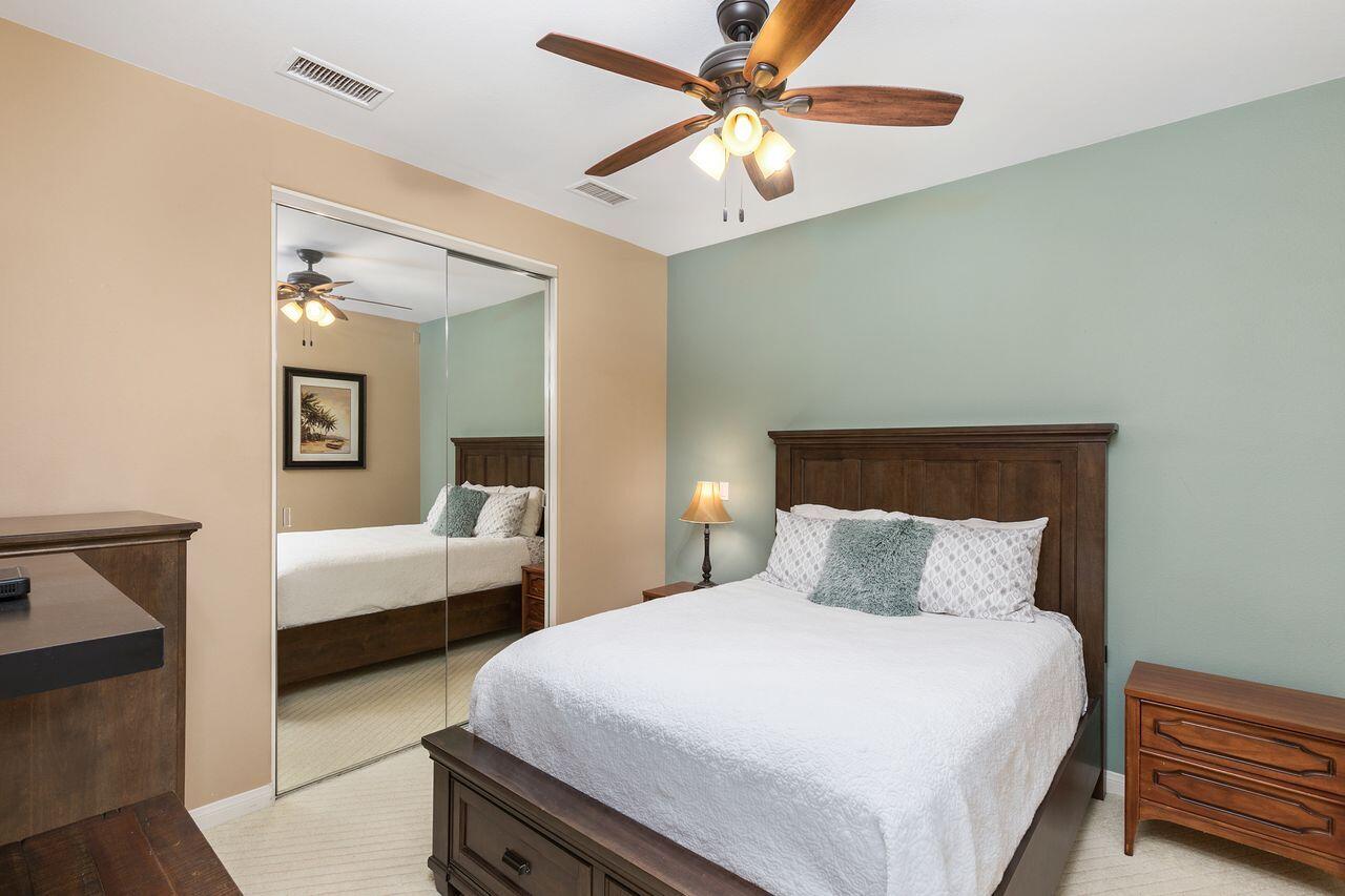 80591 Tangelo Court Indio, CA 92201 - Photo 24 of 30 a bedroom with a bed and a chandelier