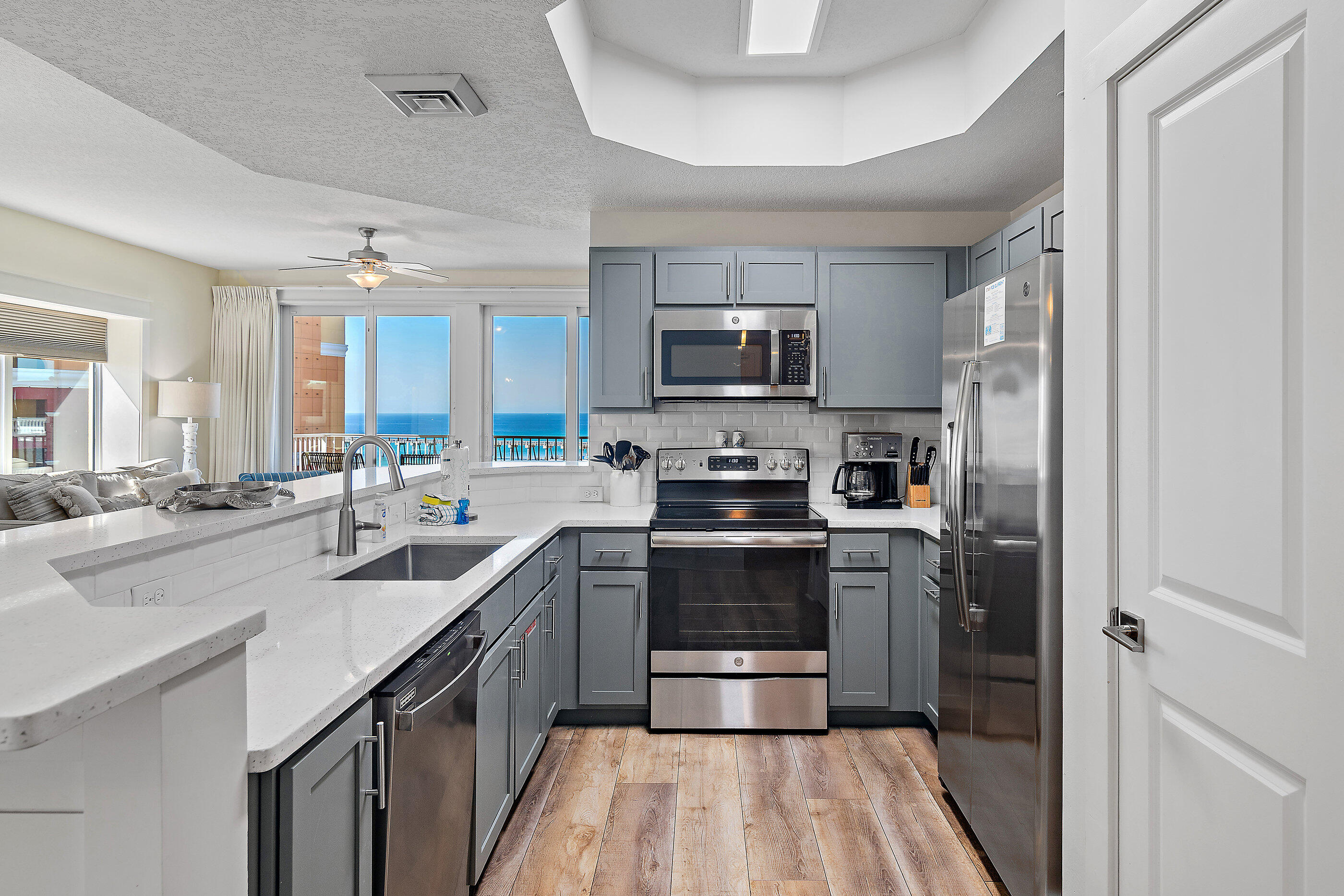 15928 Front Beach Road, Unit 601 Panama City Beach, FL 32413 - Photo 11 of 39 a kitchen with stainless steel appliances granite countertop a sink stove and refrigerator