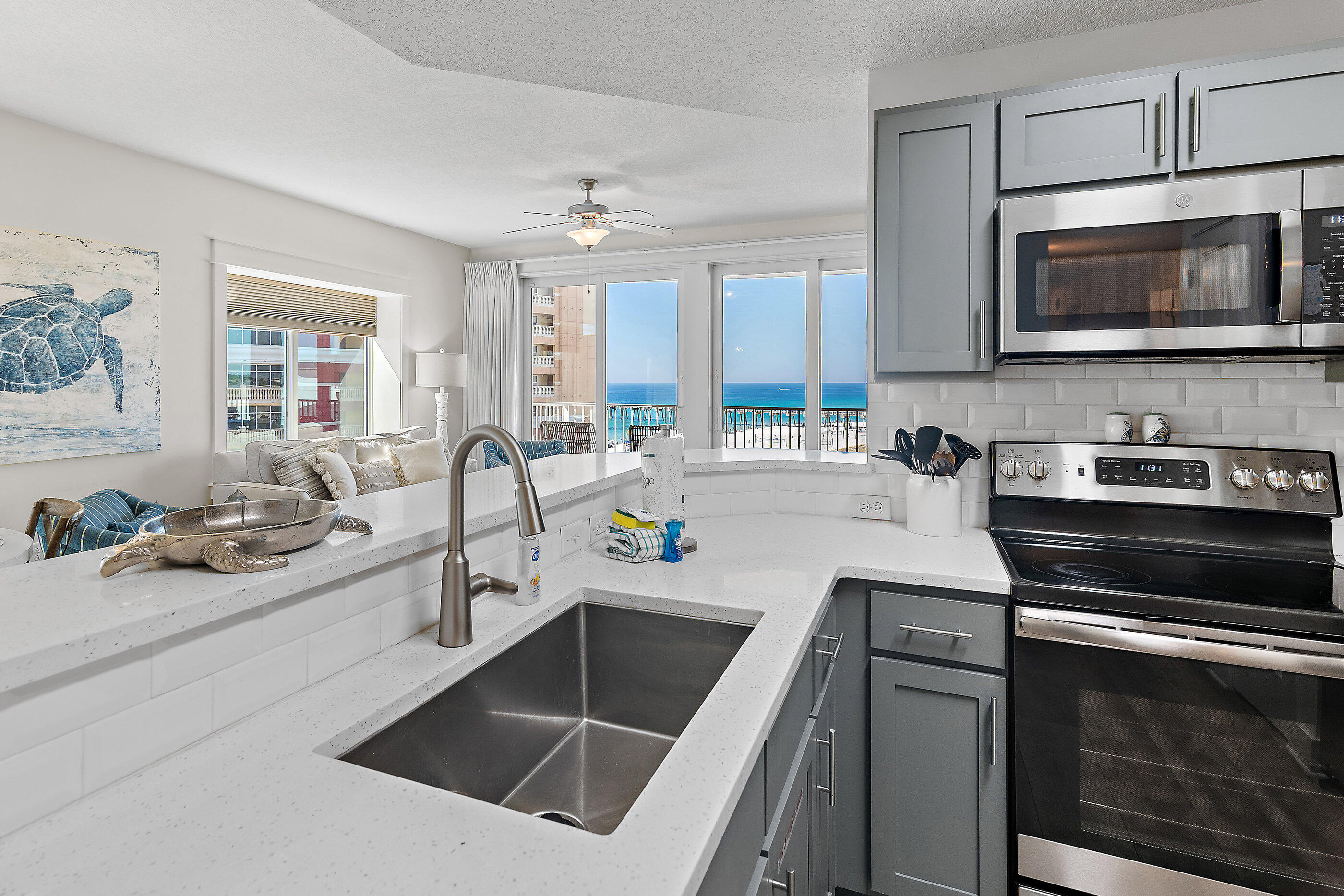 15928 Front Beach Road, Unit 601 Panama City Beach, FL 32413 - Photo 12 of 39 a kitchen with stainless steel appliances a stove microwave and sink