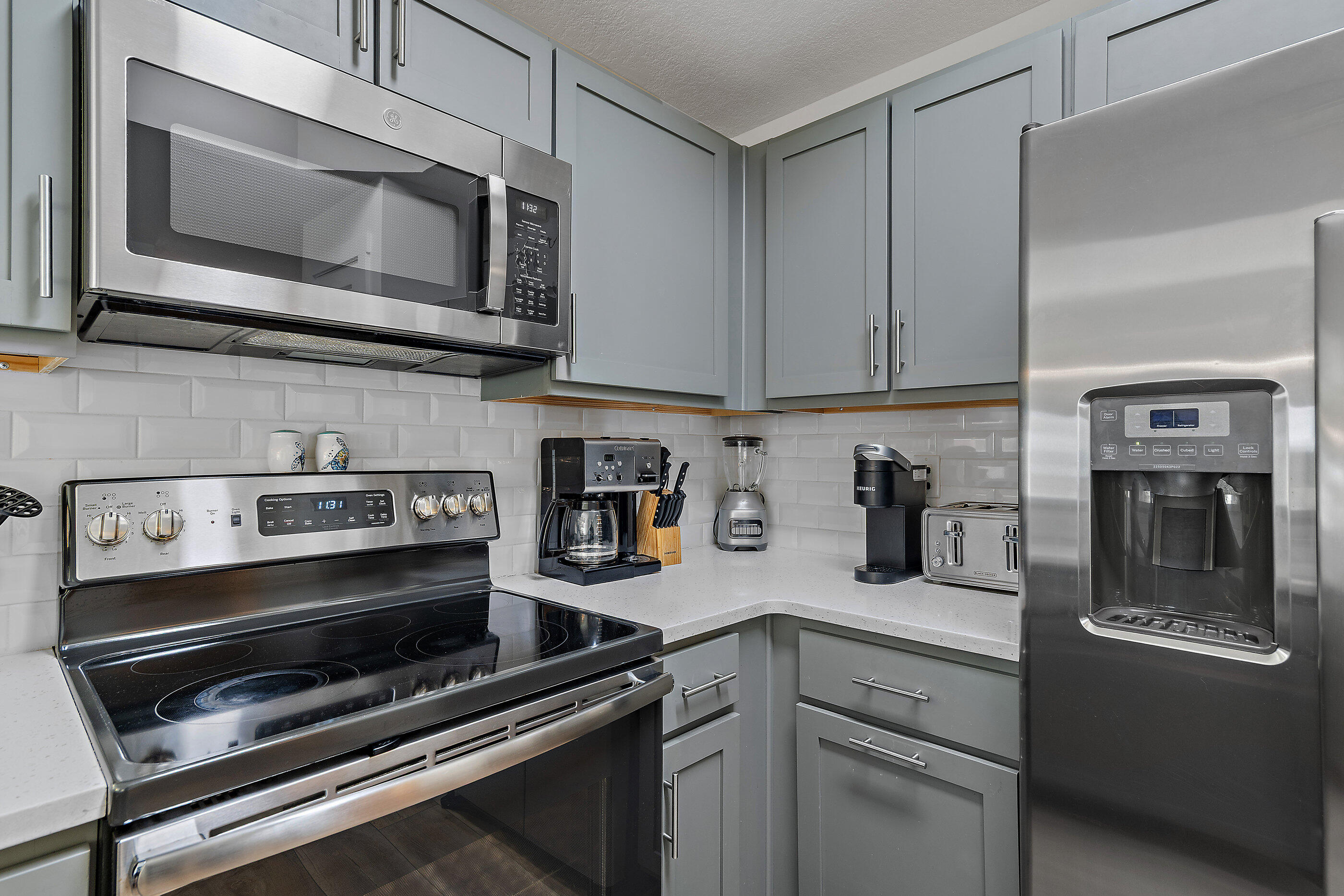 15928 Front Beach Road, Unit 601 Panama City Beach, FL 32413 - Photo 13 of 39 a kitchen with a stove and a microwave
